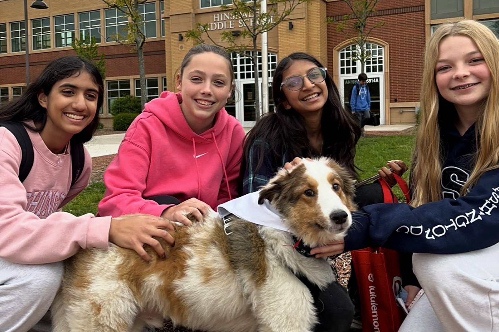 Students with a therapy dog outside Hinsdale Middle School