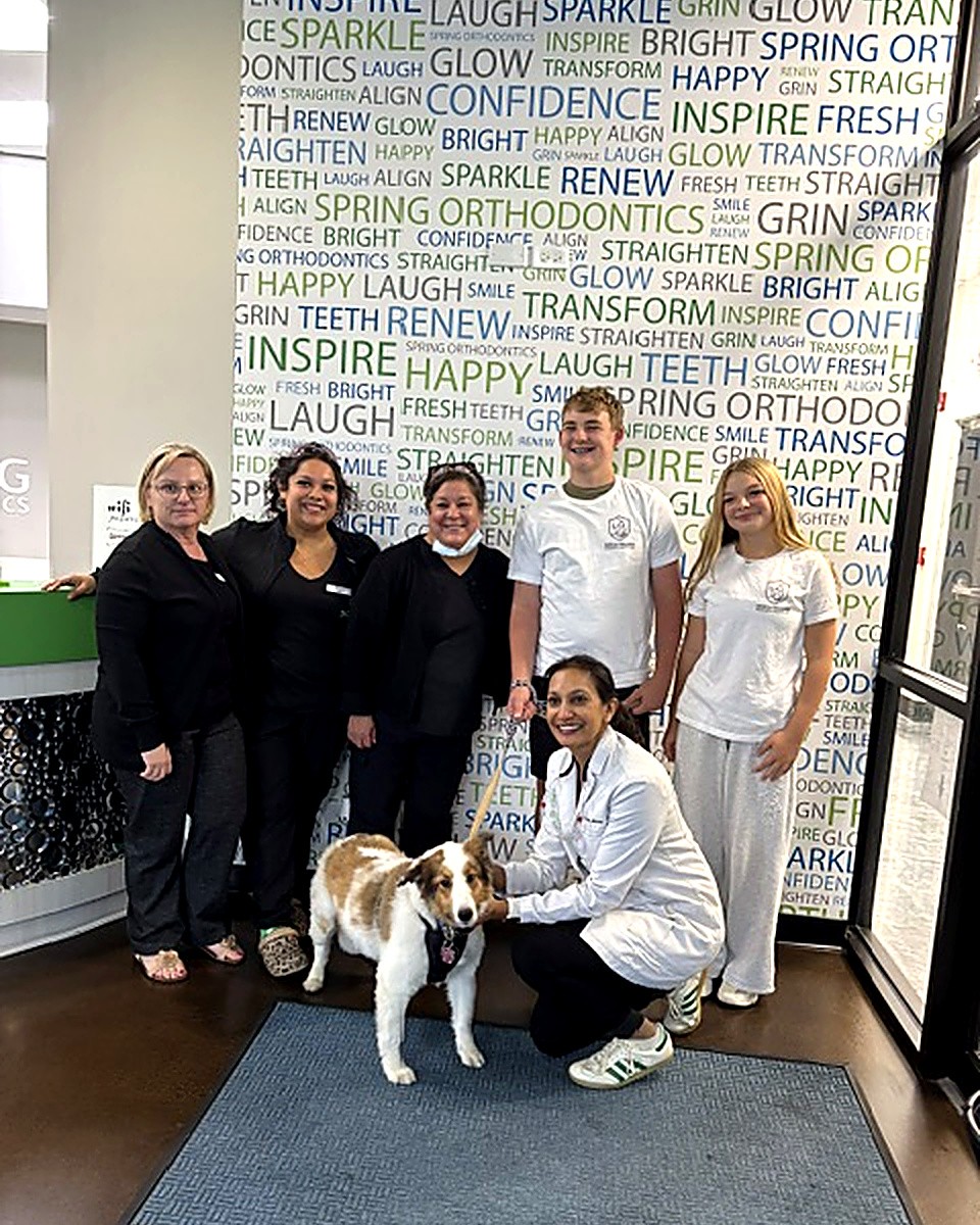 The Spring Orthodontics team with the therapy dog at their office