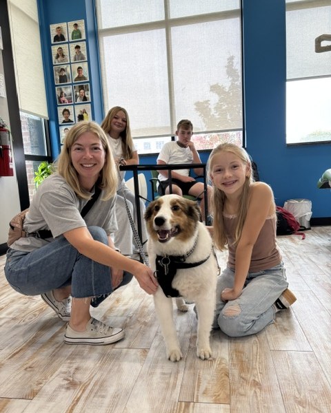 Staff and students with the therapy dog at Spring Orthodontics