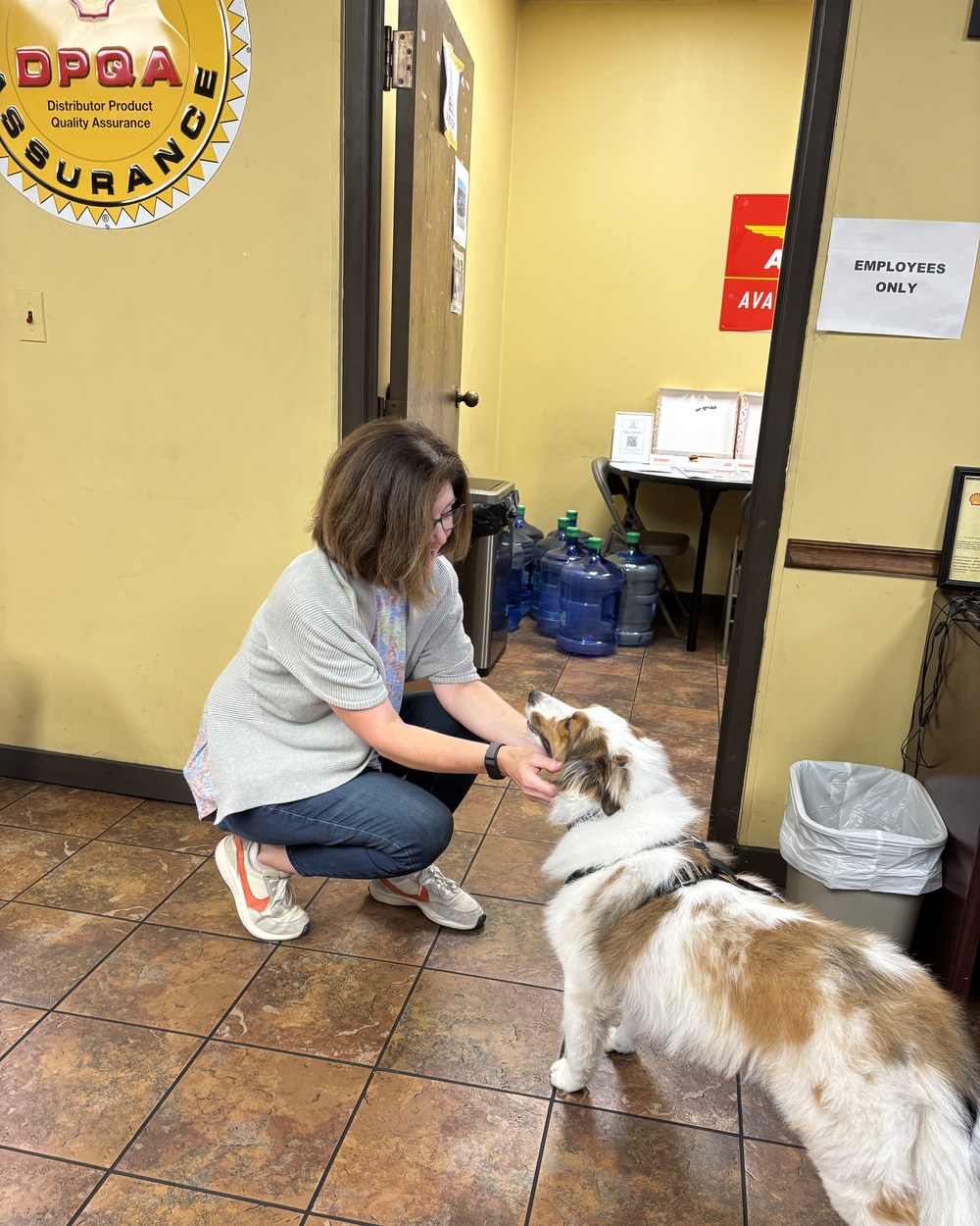 A staff member greets the therapy dog at Keller-Heartt
