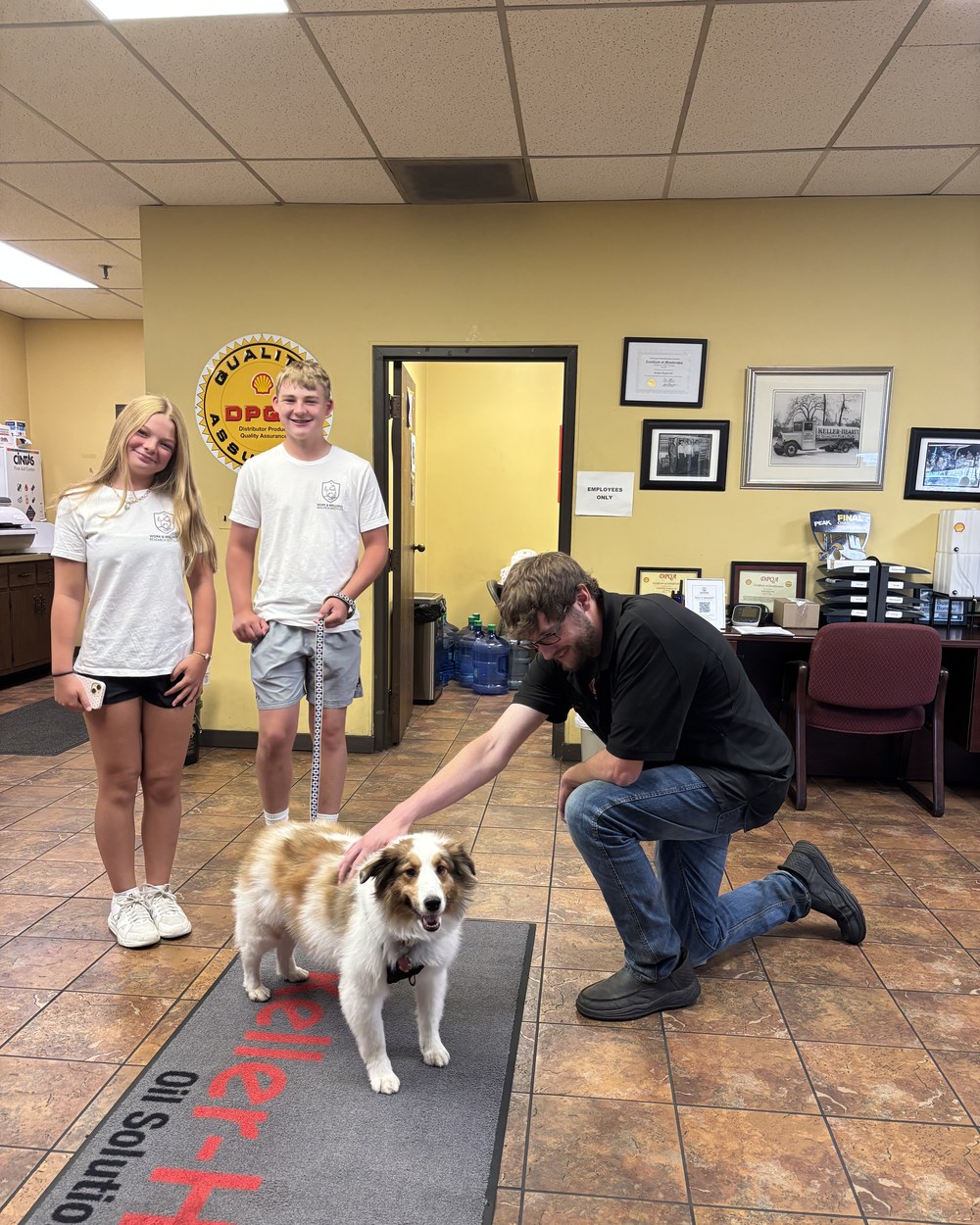 A staff member with the therapy dog in the Keller-Heartt office